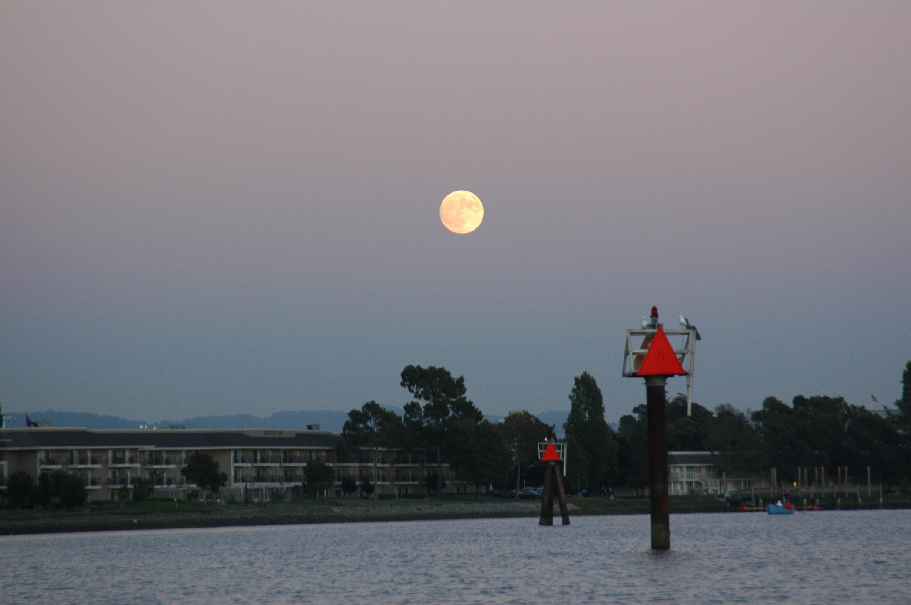 Moon rise over near base, row boat coming out bottom right corner 